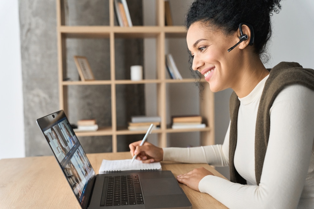 A woman on a conference call going over sales enablement services with potential clients