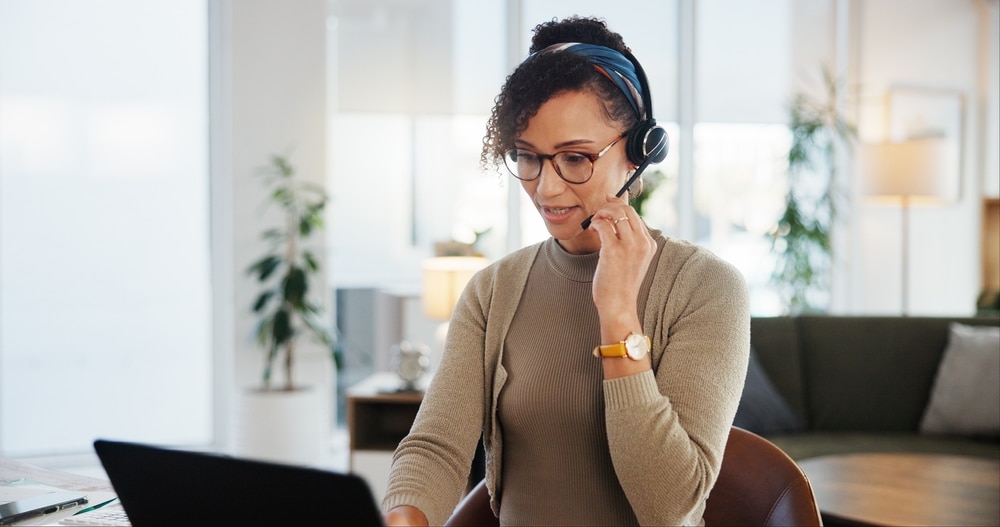 A saleswoman sitting at a computer following up on home service leads
